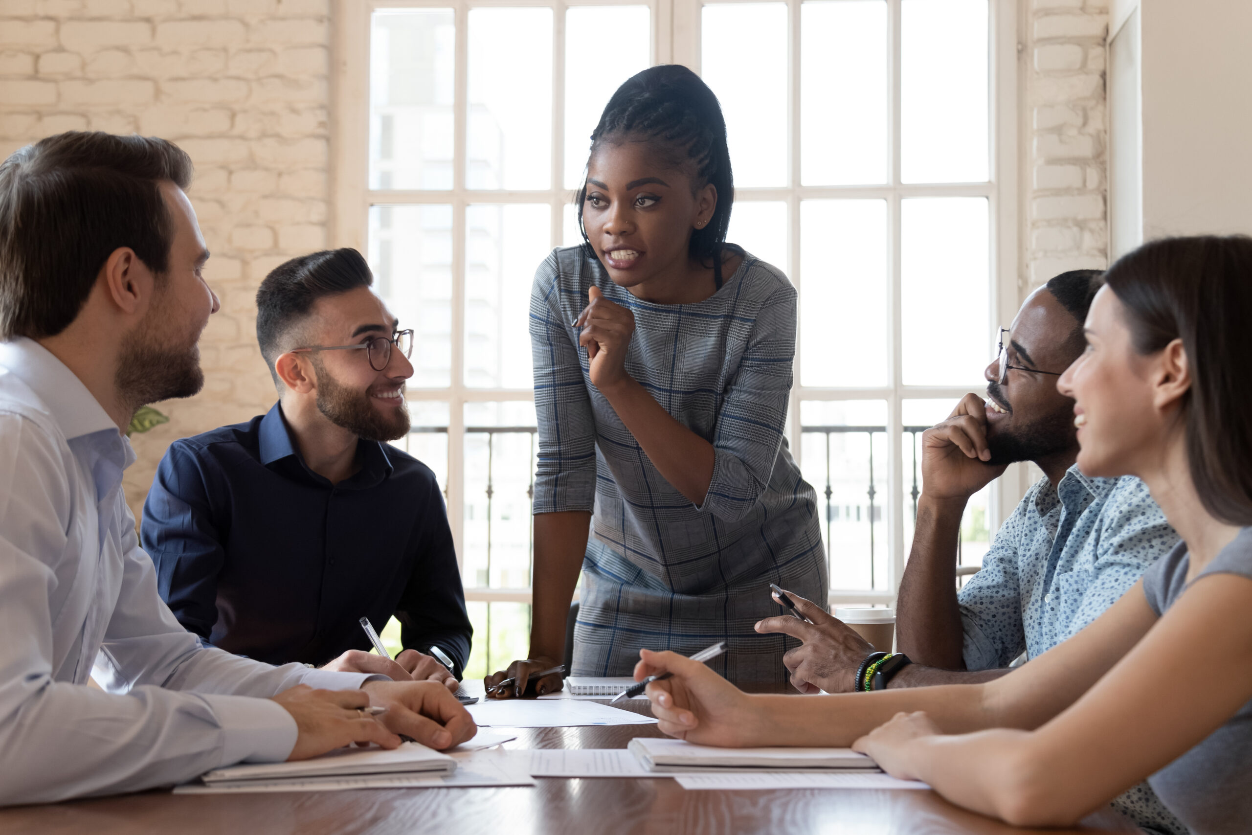 Female,Black,Executive,Leader,Talking,To,Happy,Diverse,Employees,Group