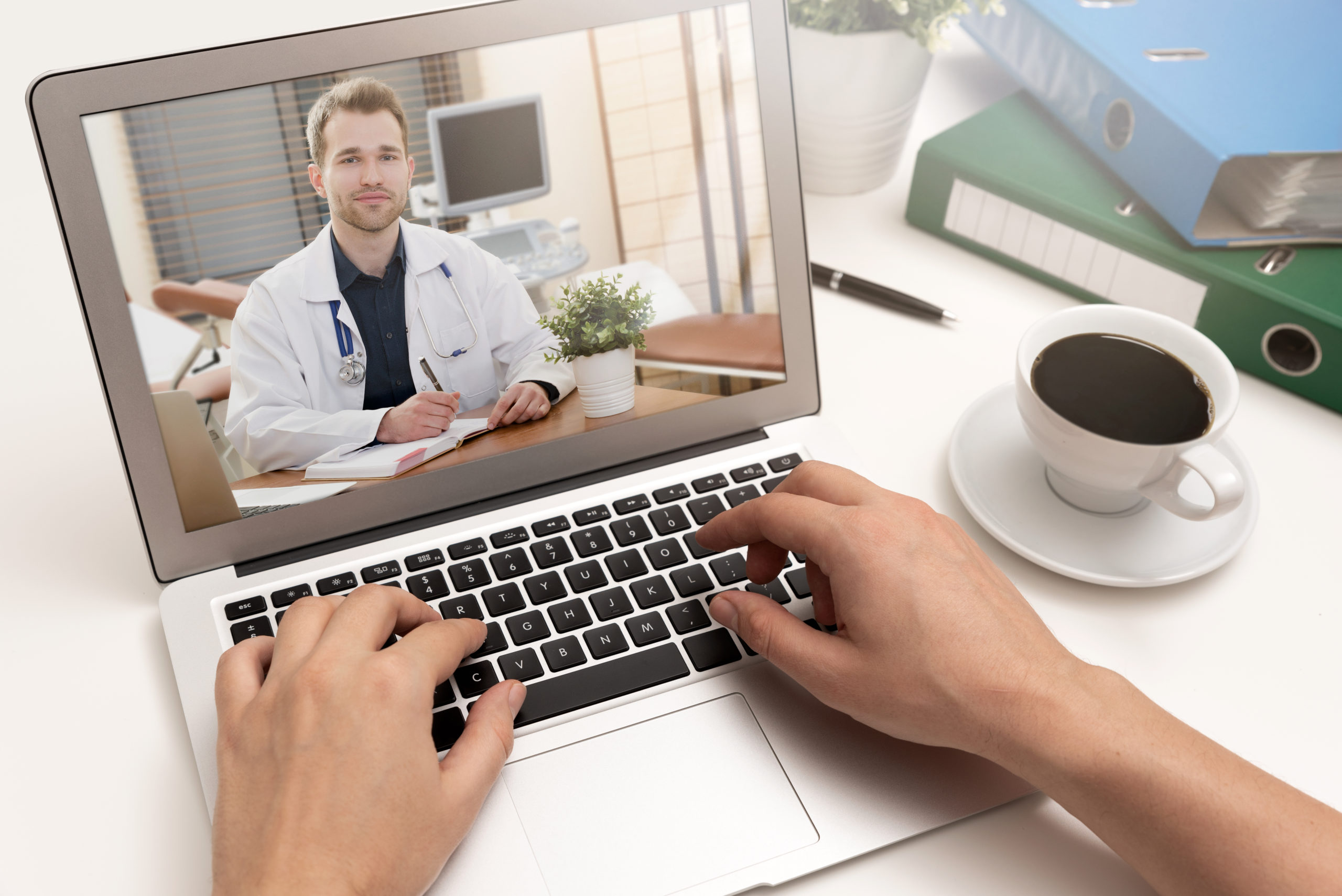 shutterstock_1288779127 Doctor with a stethoscope on a laptop screen.